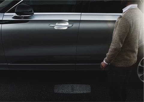 A person approaches a 2023 Lincoln Aviator® Grand Touring as the Lincoln Embrace sequence of welcome lighting illuminates | Kirk Brothers Lincoln of Vicksburg in Vicksburg MS