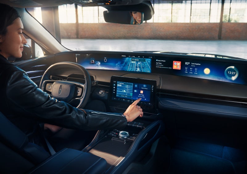 The driver of a 2024 Lincoln Nautilus® SUV interacts with the center touchscreen. | Kirk Brothers Lincoln of Vicksburg in Vicksburg MS