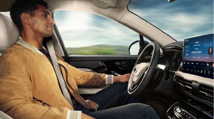 A person is shown using Lincoln BlueCruise hands-free highway driving technology on a divided highway called a Hands-Free Blue Zone. | Kirk Brothers Lincoln of Vicksburg in Vicksburg MS