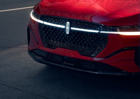 The available front LED light bar and center Lincoln Star logo glow at dusk. | Kirk Brothers Lincoln of Vicksburg in Vicksburg MS