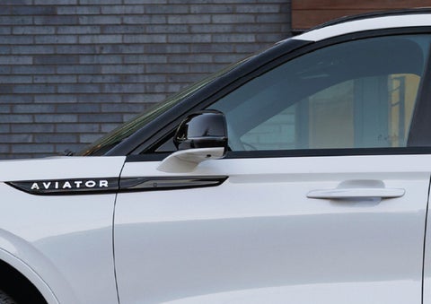 The driver’s side door and fender badging of a white 2026 Lincoln Aviator® SUV are showcased. | Kirk Brothers Lincoln of Vicksburg in Vicksburg MS