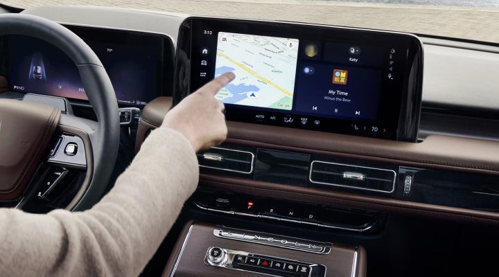 A person is tapping the center display touchscreen of a 2026 Lincoln Aviator® SUV. | Kirk Brothers Lincoln of Vicksburg in Vicksburg MS