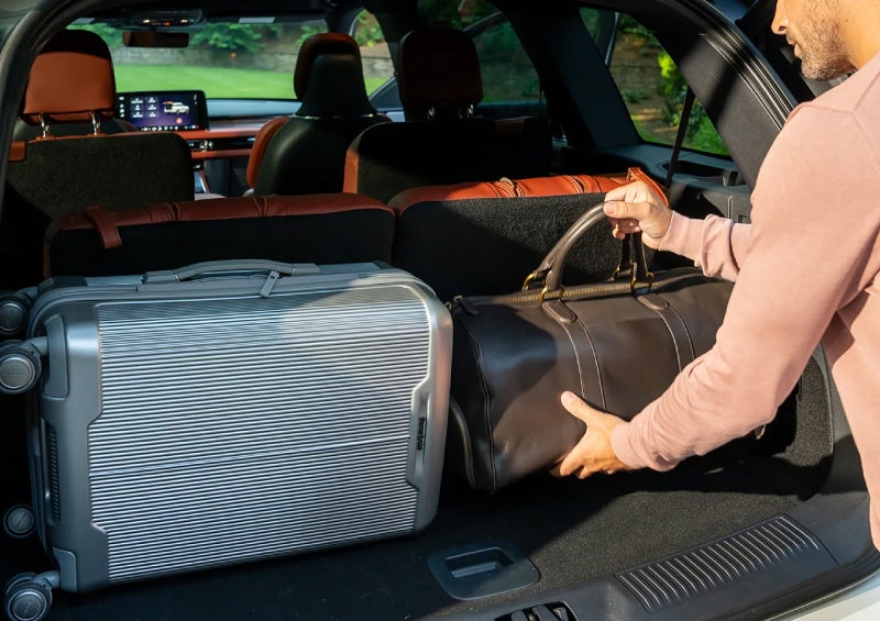 A man loads luggage into the rear of a 2026 Lincoln Aviator® SUV through the opened rear liftgate. | Kirk Brothers Lincoln of Vicksburg in Vicksburg MS