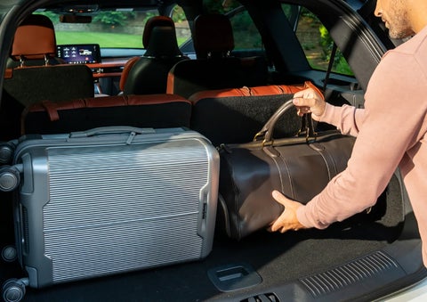 A man loads luggage into the rear of a 2026 Lincoln Aviator® SUV through the opened rear liftgate. | Kirk Brothers Lincoln of Vicksburg in Vicksburg MS
