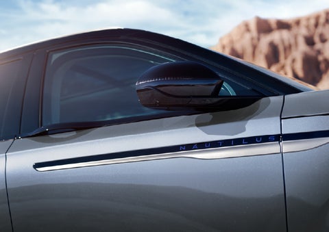 Blue lettering on the side of the vehicle that reads Nautilus indicates the available Hybrid Powertrain. | Kirk Brothers Lincoln of Vicksburg in Vicksburg MS