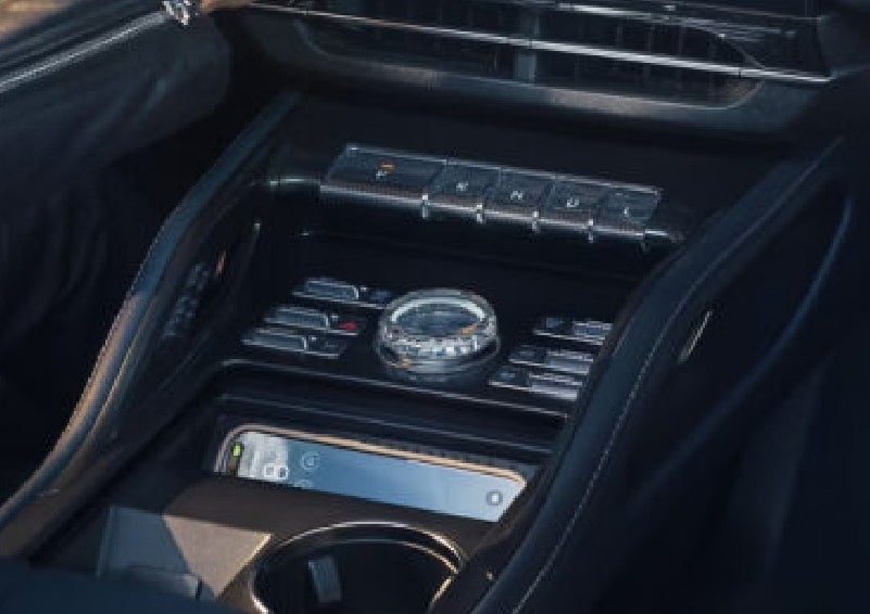 A smartphone is shown charging in the wireless charging pad. | Kirk Brothers Lincoln of Vicksburg in Vicksburg MS